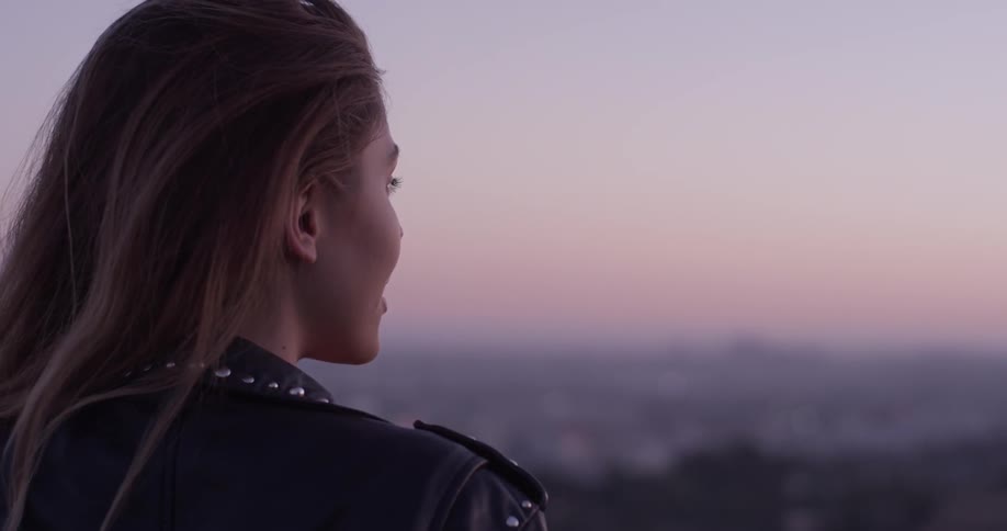 A woman is outside looking around