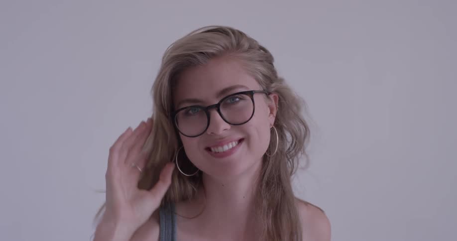 A woman that is flipping her hair over her head