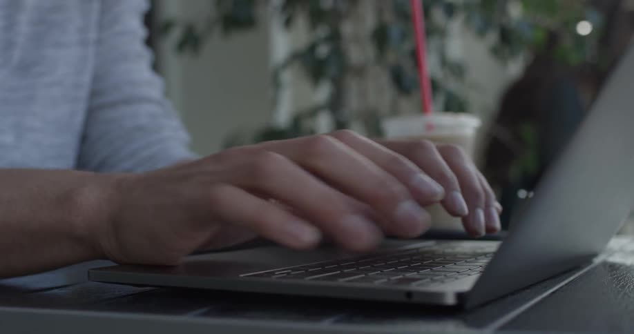 A man typing on a laptop computer