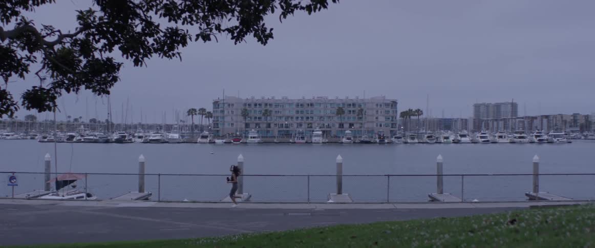 A woman running next to a river