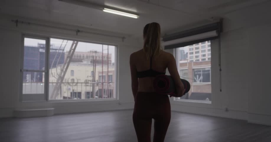 Woman Doing Yoga In Empty Building