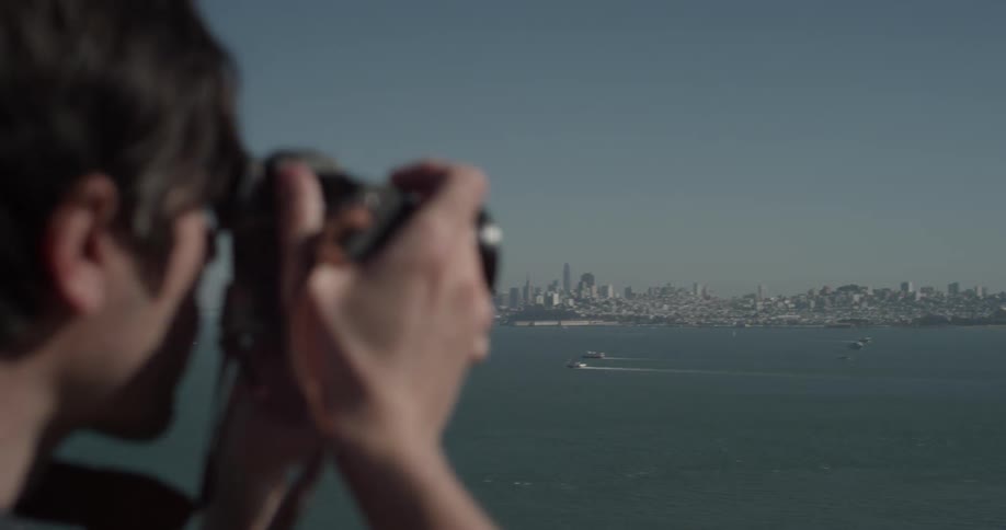 Man using a camera to take some photos of a city