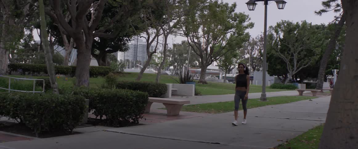 A woman walking down a sidewalk