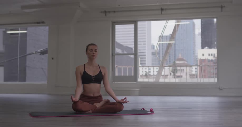 Woman Doing Yoga In Empty Building