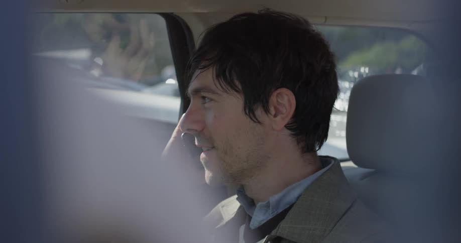 Man answering a phone in a car