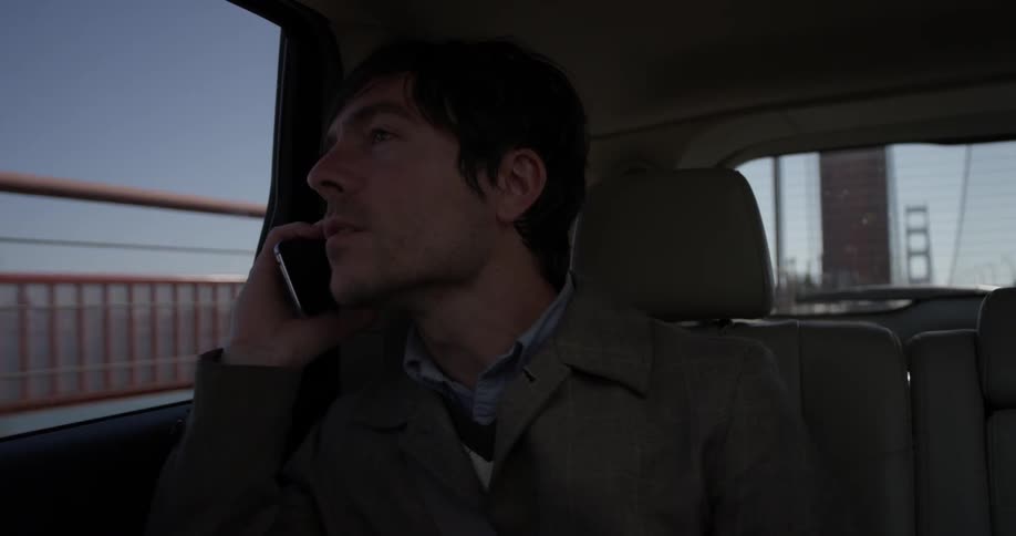 Man talks on cell phone while riding in car