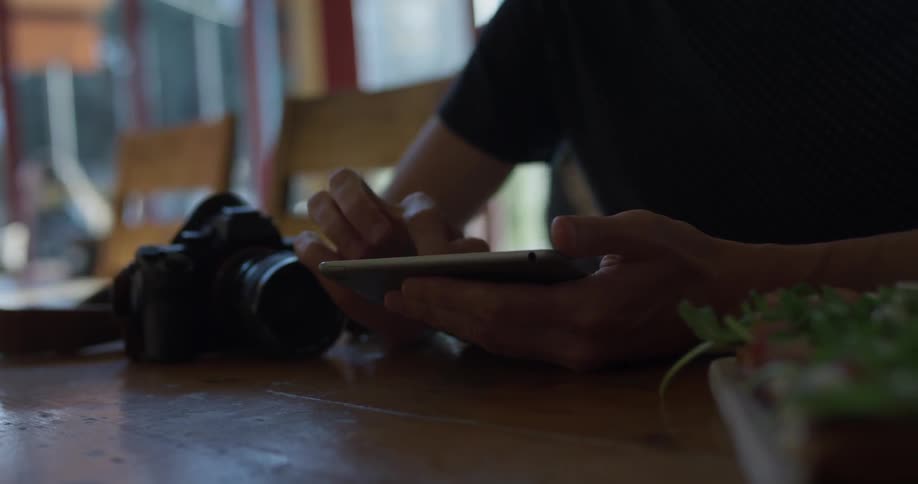 A person using a tablet at a table