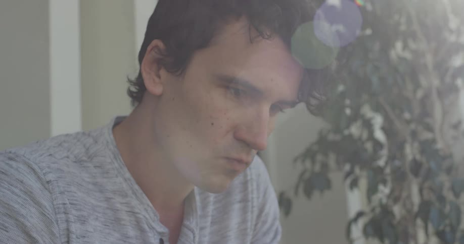 Man looking off a balcony at something