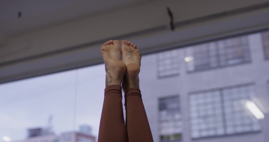 A woman doing yoga in a gym