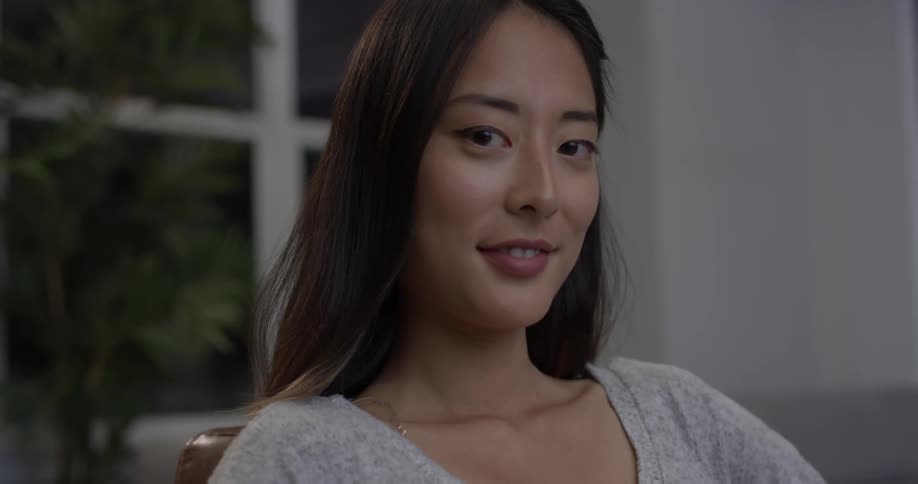 Woman smiles faintly as she looks around