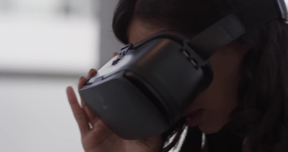 Woman wearing yr headset peers around