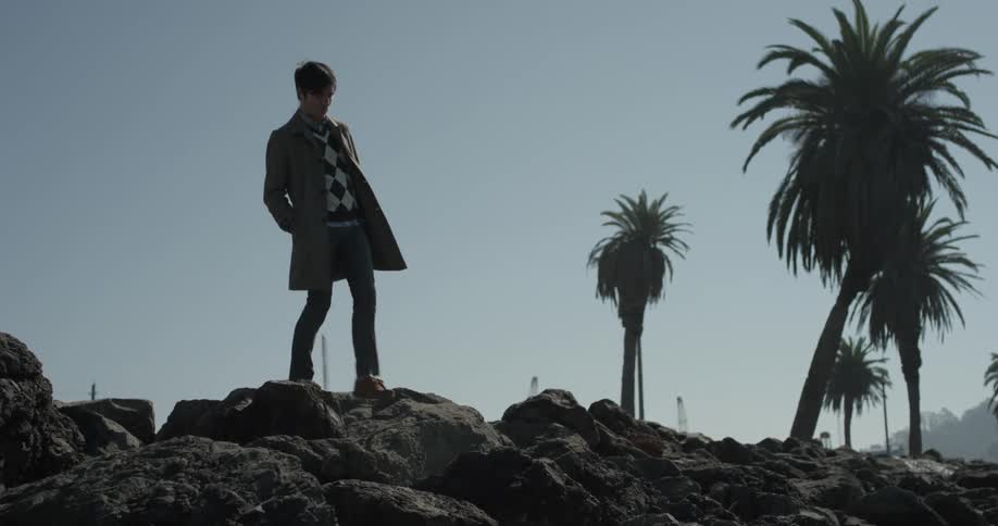 Man stands on the rocks looking out