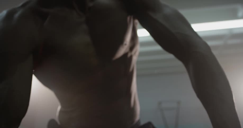 A man uses a dumbbell to do curls