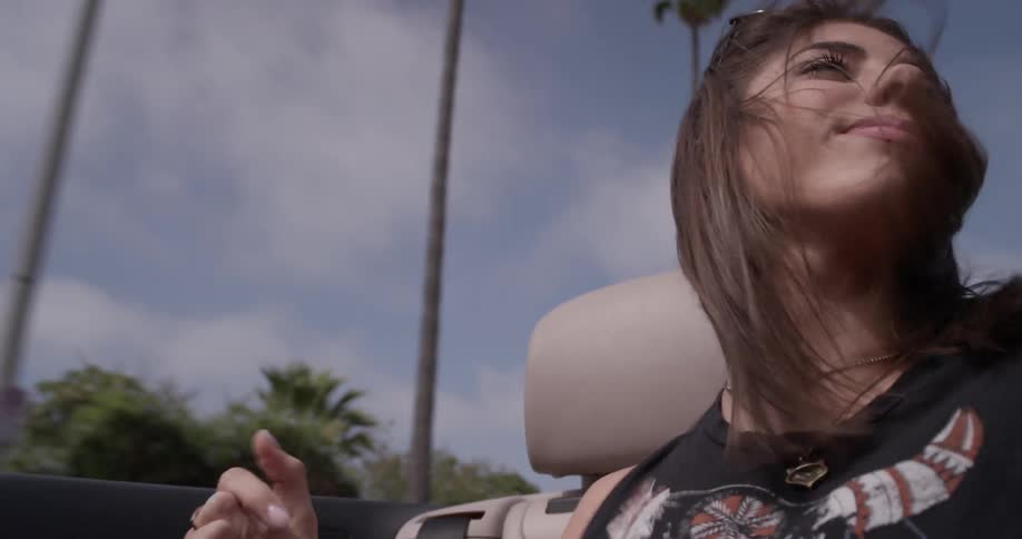 A woman dancing in a moving vehicle
