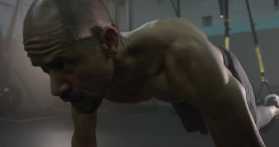 A man doing pushups in a gym