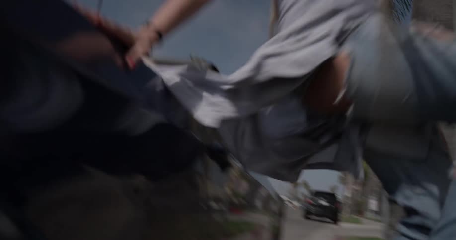 A woman jumps out of a convertible car