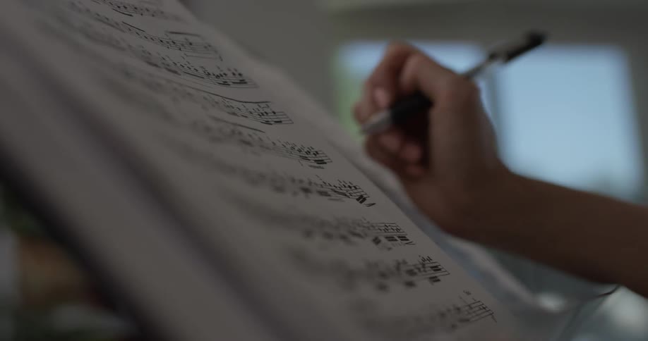A person reading through sheet music