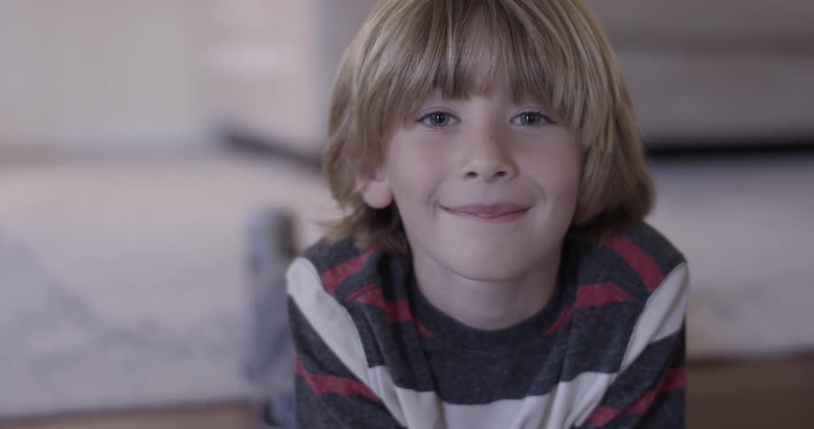 Young boy looks up and tries not to smile