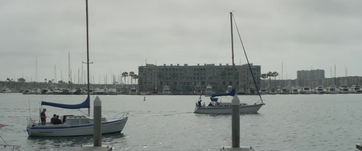 A boat sailing along next to a city