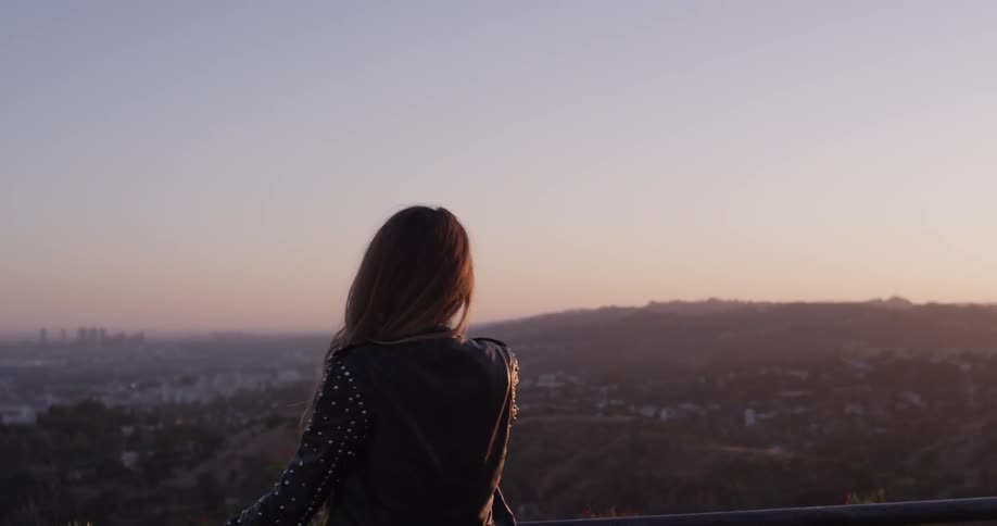 A woman is taking a video of the skyline