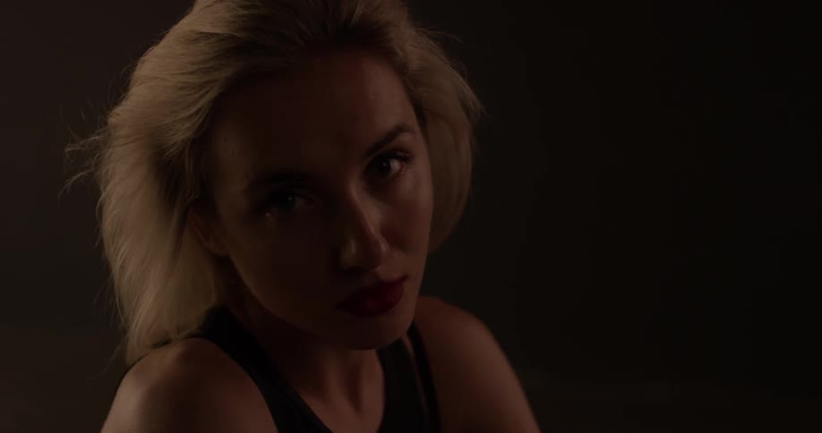 A woman is glancing around indoors