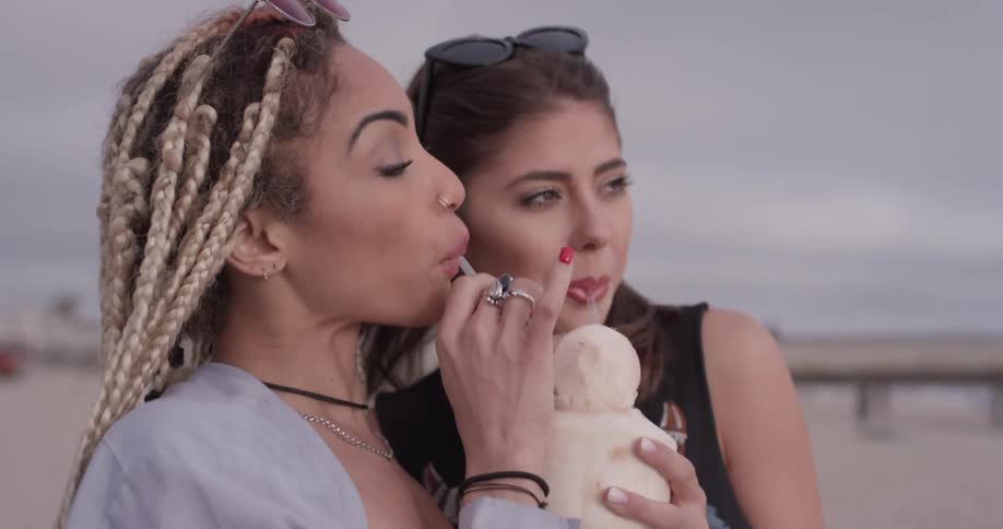 Two women sharing a root beer float
