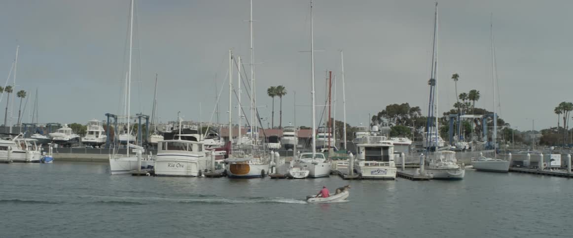 A boat that is going past a harbor
