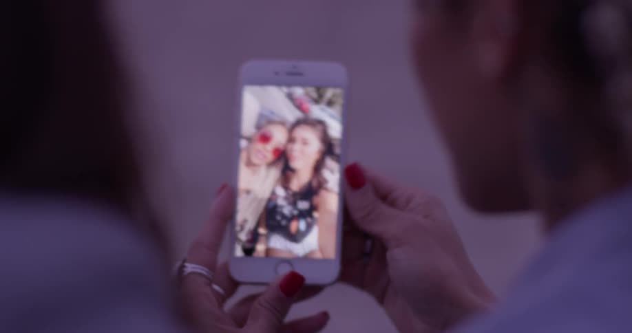 Two woman looking at pictures on a cell phone