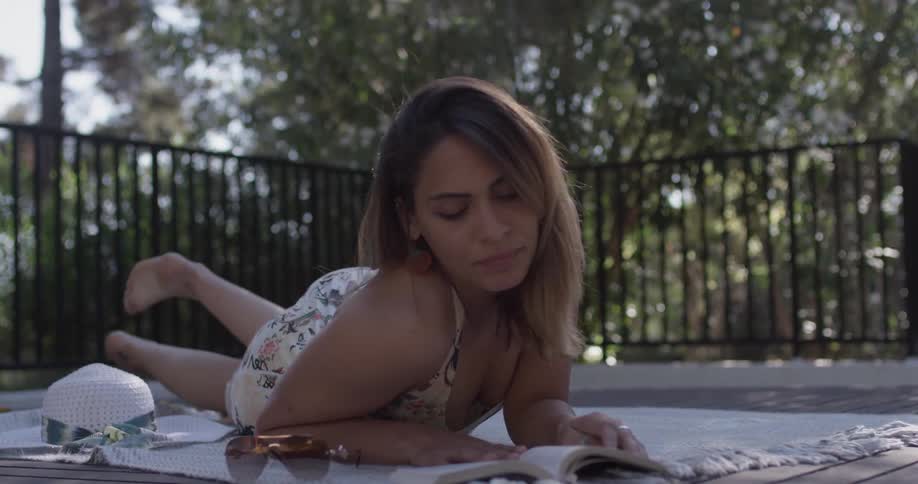 Woman Relaxing By The Pool