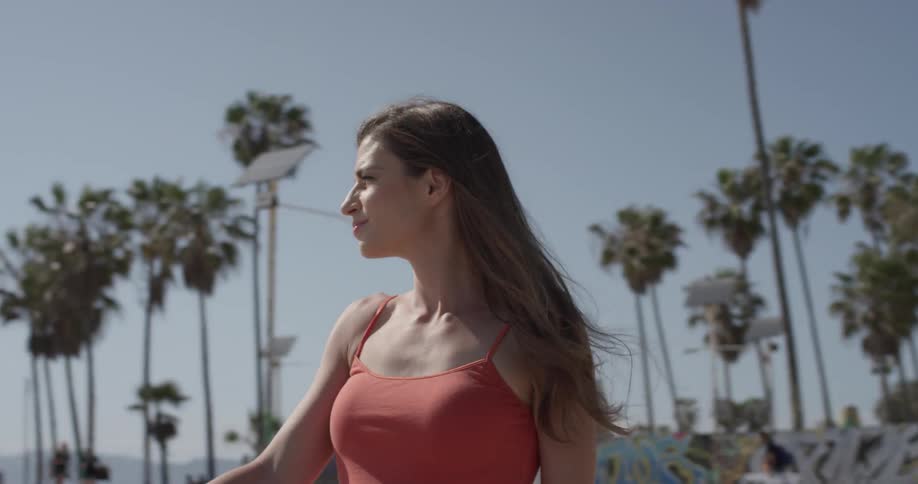 A woman is looking around outside