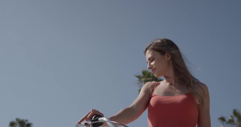 A woman is riding a bicycle outside
