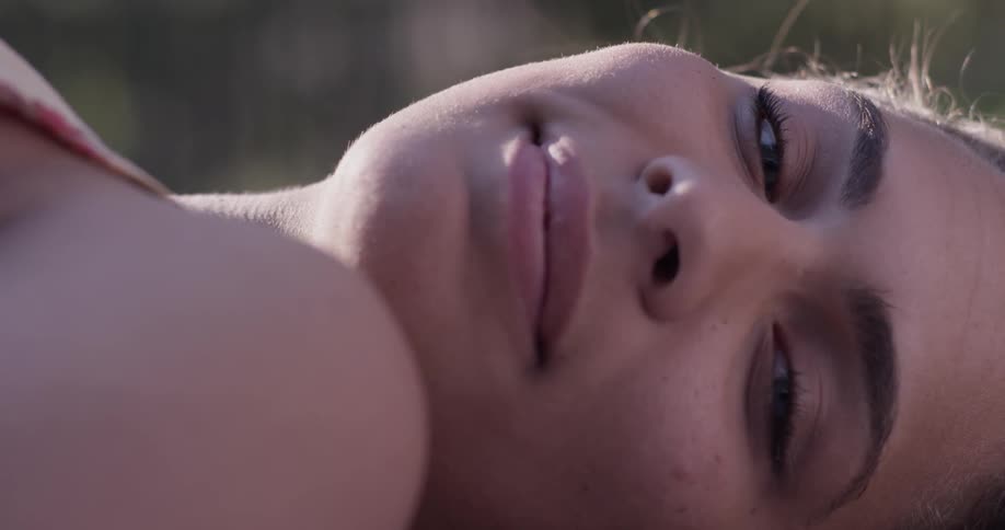 A woman is laying down outside