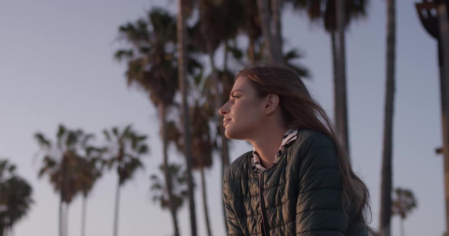 Woman sitting outside near the ocean