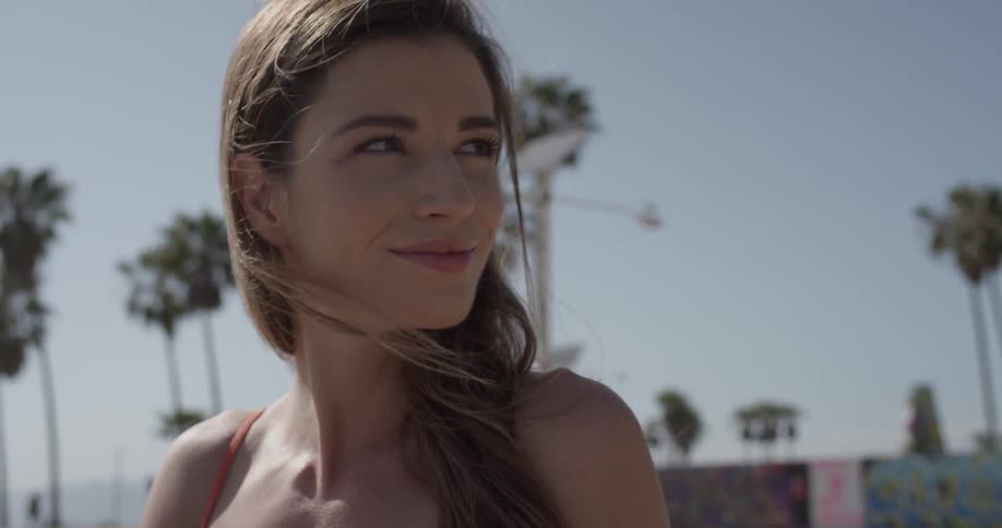 A woman is smiling while standing outside