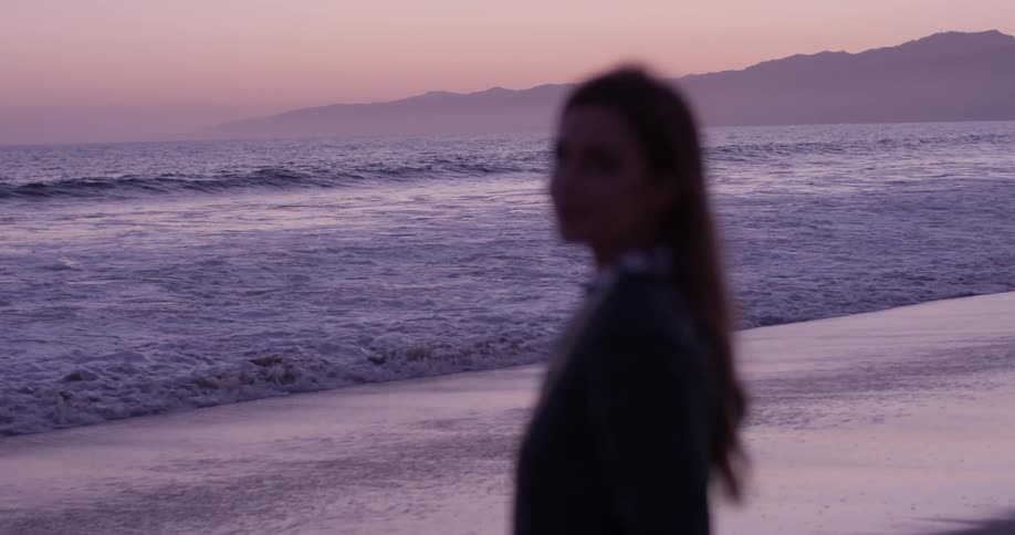 A woman looks out over the ocean