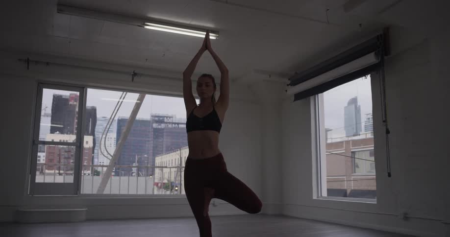 A woman is doing yoga indoors