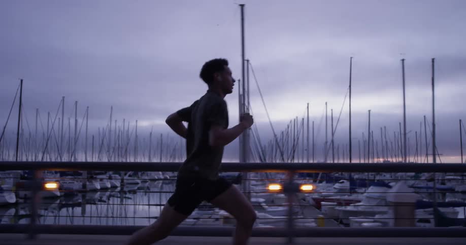 A man running down next to some docks
