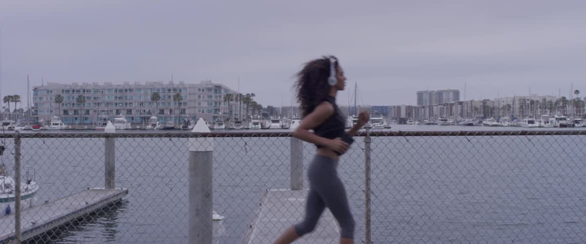 Woman running down a sidewalk