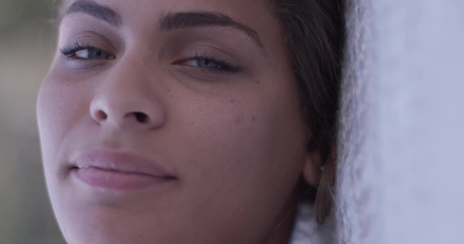 Woman lays on a blanket outside