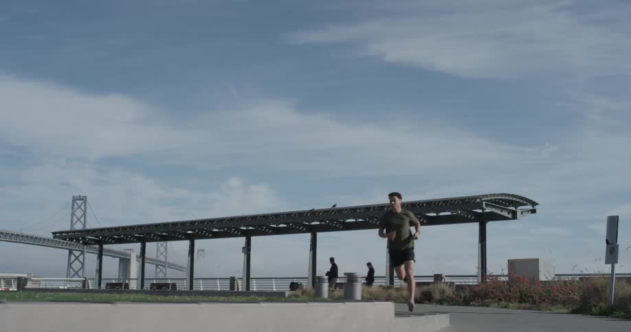 A man running down a sidewalk