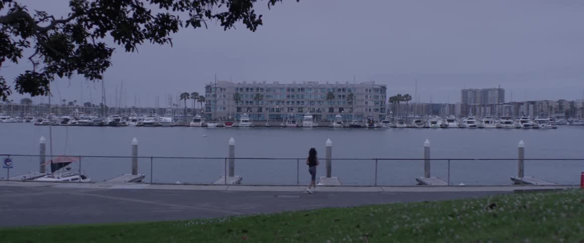 A woman is jogging outside by the beach