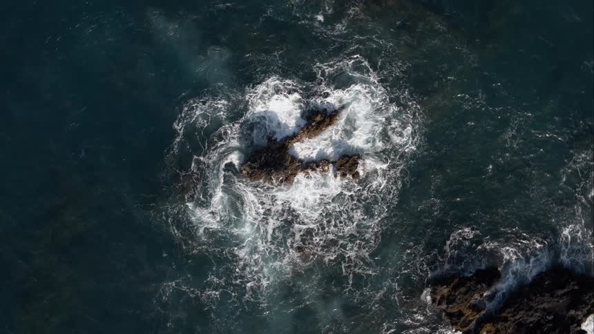 Waves are crashing by the rocks