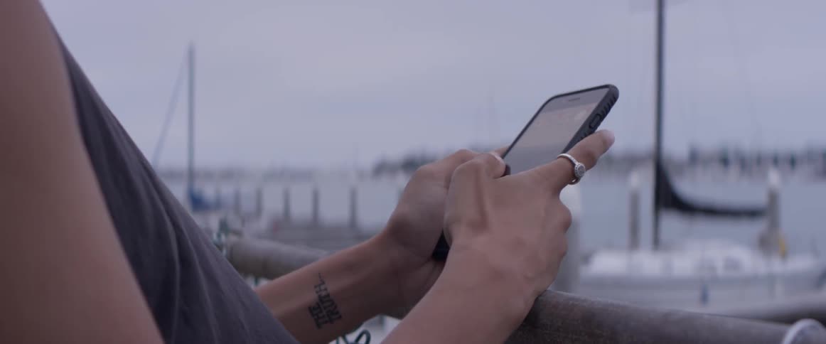 A person typing on a cell phone