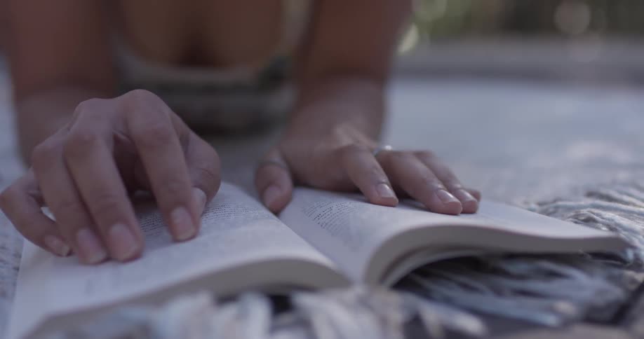 A woman is reading a book indoors