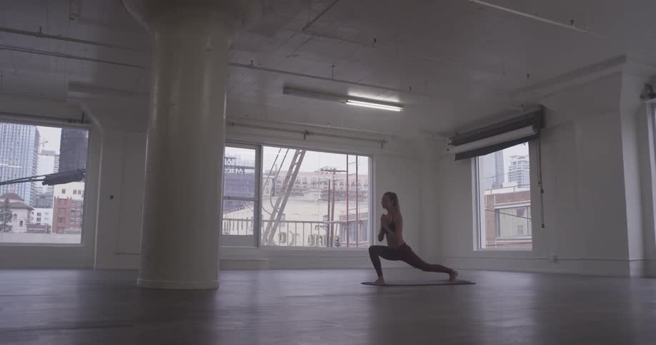 Woman Doing Yoga In Empty Building