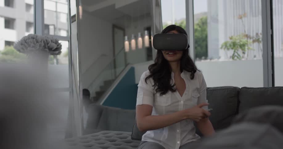 A woman playing a virtual reality game and poking at the air