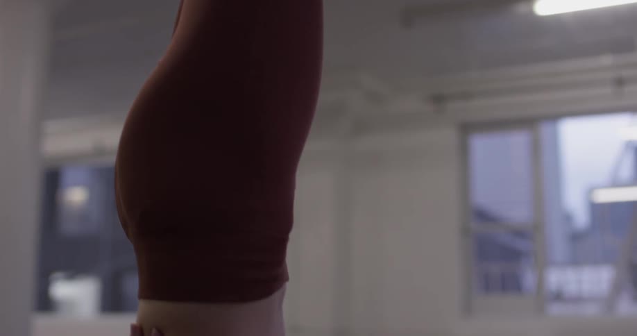 Woman Doing Yoga In Empty Building