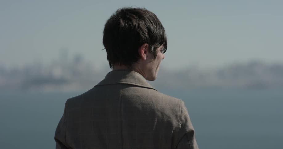 Man looking into the distance at a city