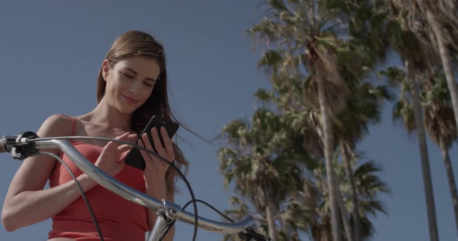 Woman typing on a cell phone outdoors