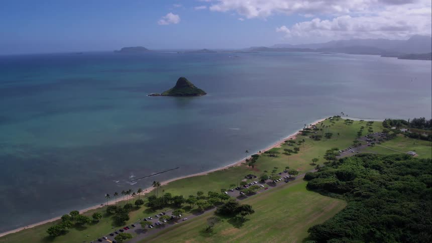 Rocky island  is separated from the land by blue ocean
